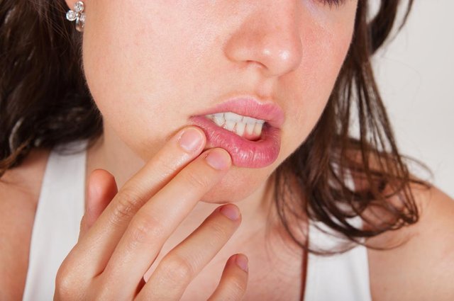 Woman with a citrus allergy holding her mouth