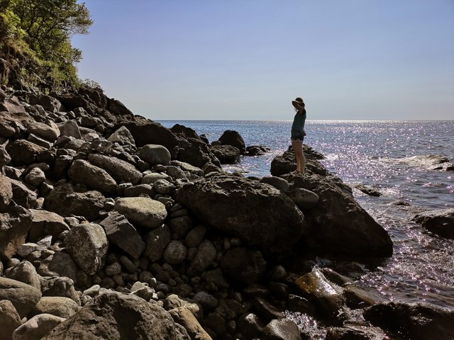 Girld on rocks near the Black Sea in Kvariati Town, Georgia