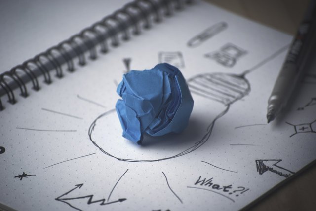 Doodle of a lightbulb with a ball of blue clay on top