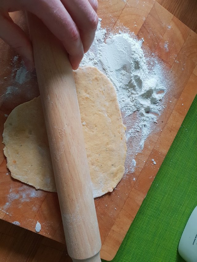 rolling out a sweet potato flatbread