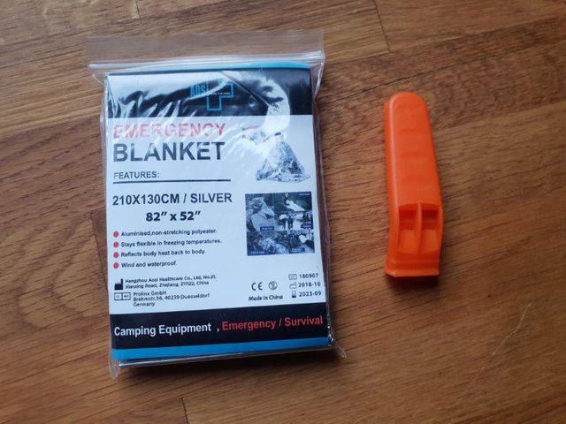 first aid kit white and thermal blanket