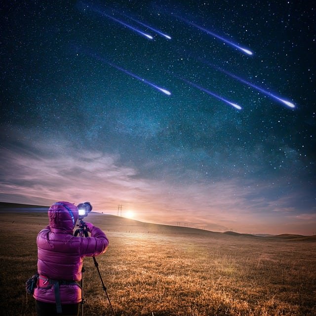 Photograher taking pictures of a meteor shower.