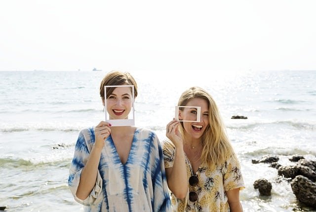 Friends at the beach, having fun posing for the camera.