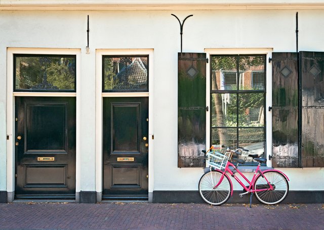 Facade with 2 odd doors and a window