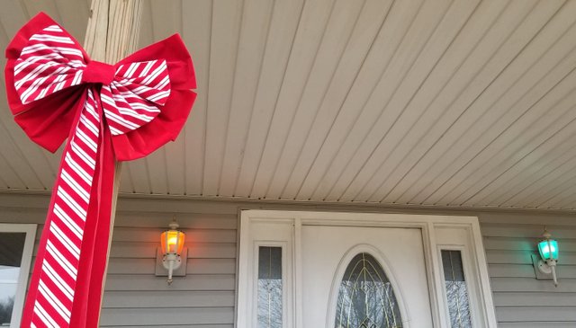 20191222_110439 Christmas ribbon with red and green porch lights.jpg