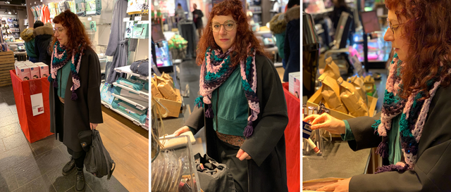 a woman wearing a handmade outfit and a crochet shawl while buying coffe in a shop