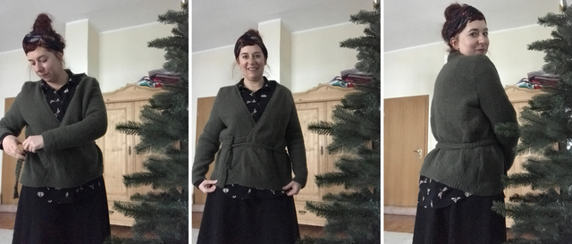 smiling woman standing besides a Christmas tree presenting a handmade wrap cardigan
