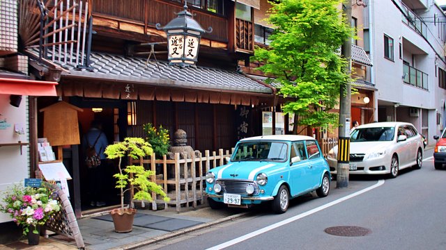 Old mini car front of typical restaurant