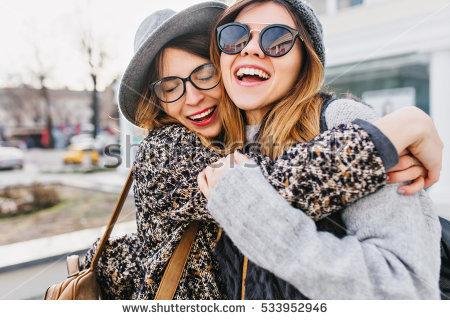 stockphotohappybrightfulpositivemomentsoftwostylishgirlshuggingonstreetincitycloseupportrait533952946.jpg