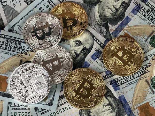 hundred-dollar-bills-and-bitcoin-coins.jpg