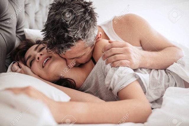 67345663-man-kissing-his-girlfriend-on-her-neck-while-she-is-smiling-and-enjoying-early-morning-bedroom-scene.jpg