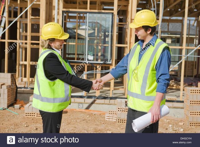 civil-engineer-and-worker-shaking-hands-at-the-construction-site-DHGCYH.jpg