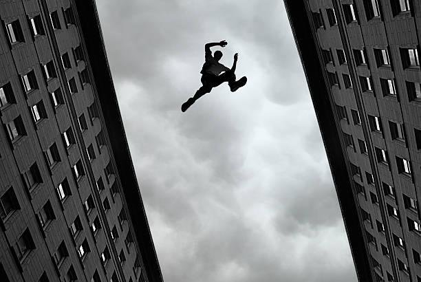 man-jumping-over-building-picture-id469150996.jpg