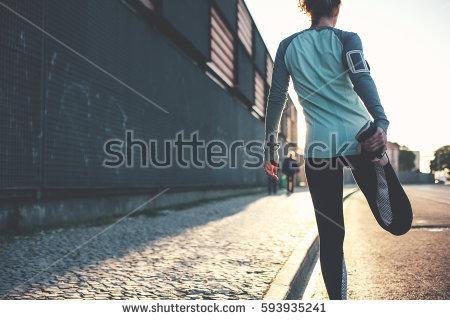 stock-photo-athlete-woman-preparing-for-running-on-the-city-street-legs-warming-and-stretching-sport-tight-593935241.jpg