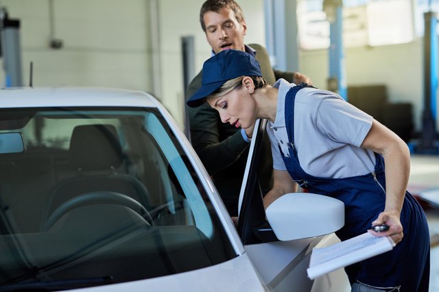 auto-repairwoman-her-customer-examining-car-problems-repair-shop (1)