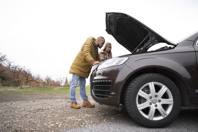 full-shot-man-checking-car-s-engine (1)