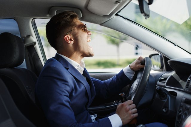 happy-businessman-sits-shows-his-emotions-sitting-steering-wheel-inside-car (1)