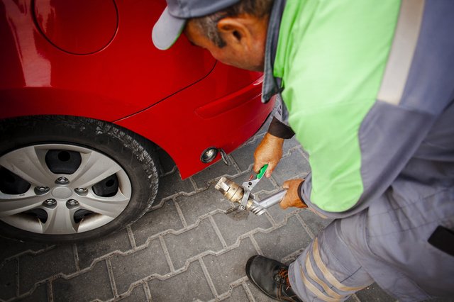 man-fixing-red-car (1)