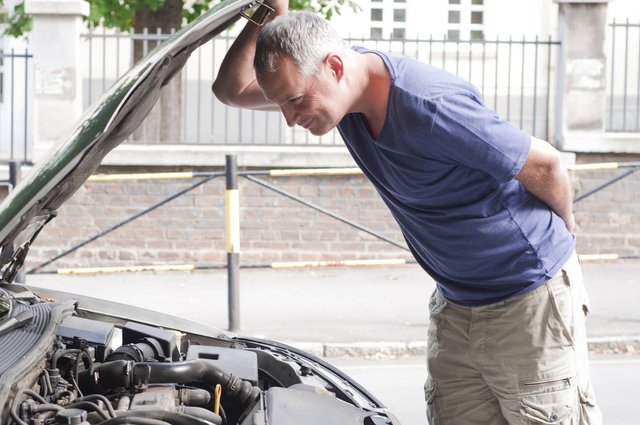 man-having-bad-day-checks-hood-his-car-figu (1)