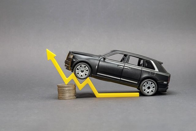 black-toy-car-stands-stack-coins-yellow-arrow-symbolizing-growth-car-sales_418821-5