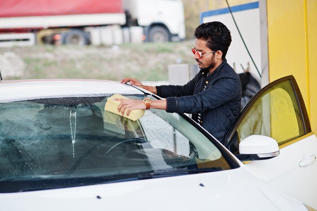 south-asian-man-indian-male-washing-his-white-transportation-car-wash (1)