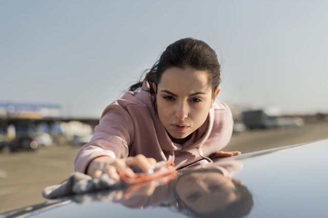 front-view-woman-cleaning-hood-car (1)