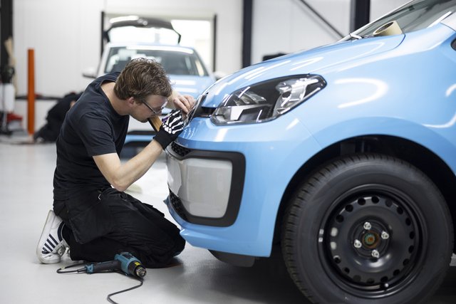 full-shot-professional-man-wrapping-car-with-blue-cover (1)