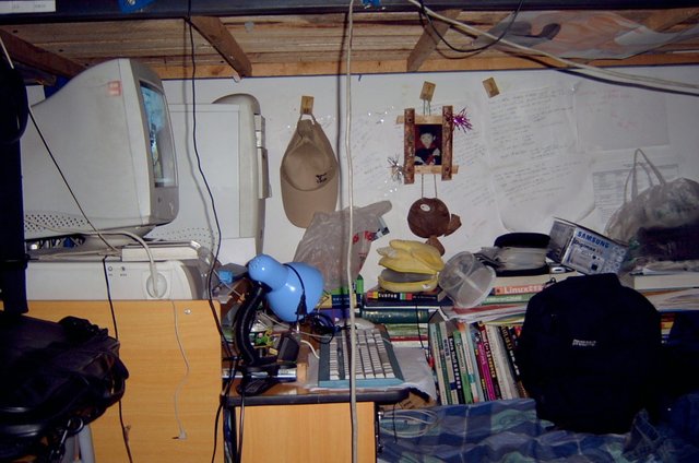 My dorm bed - messy with many computer books and a PC