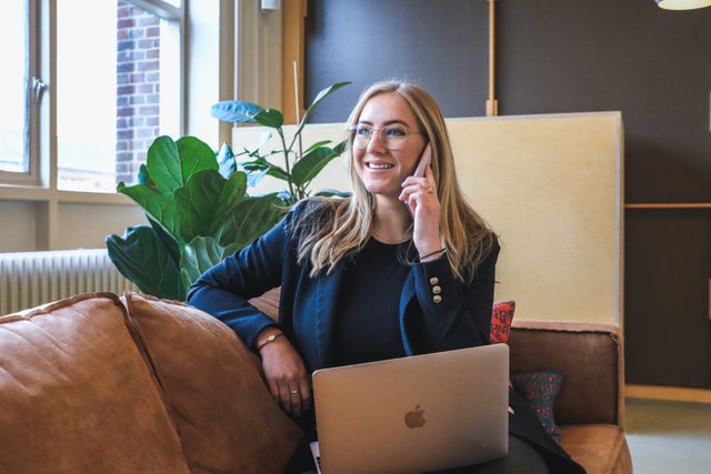 blonde business woman with phone working