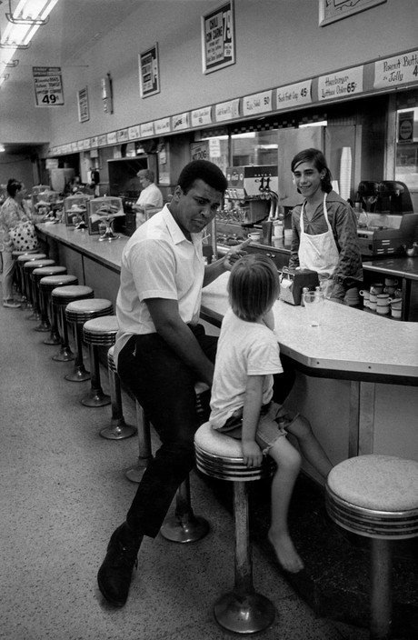 Muhammad Ali with young fan in a diner, Florida, 1970. Photograph by Danny Lyon