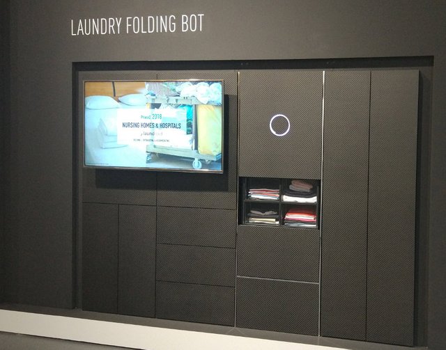 Laundry-folding robot Foldimate, left, on display at the Sands Expo and  Convention Center durin …
