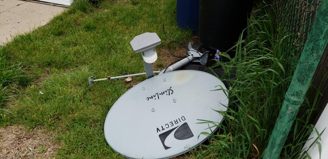 Direct TV dish that has been removed from a roof.