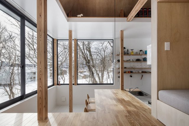 a-view-of-the-kitchen-from-the-living-room-the-reading-nookbench-is-another-layer-of-space.jpg