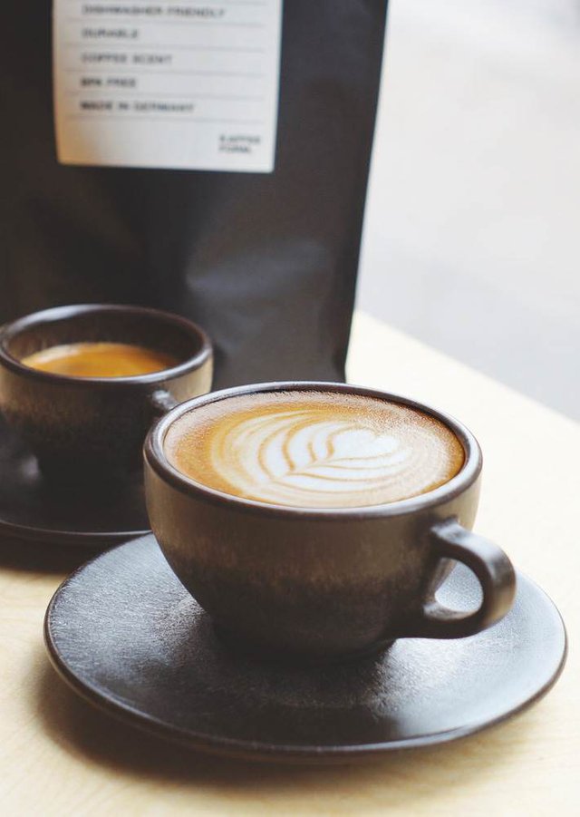 two-cappuccino-cups-with-saucers-coffee-grounds.jpg