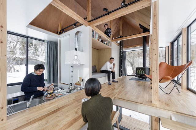 inside-the-open-plan-layout-features-a-kitchen-which-morphs-into-the-living-area-with-a-raised-built-in-benchreading-nook-along-with-an-upper-level-that-overlooks-the-space.jpg