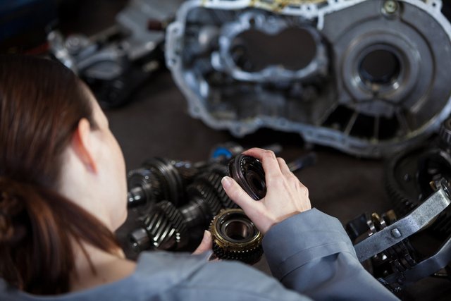 female-mechanic-fixing-gear-1