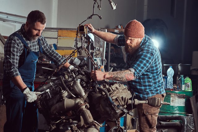 two-bearded-mechanics-specialist-repairs-car-engine-which-is-raised-hydraulic-lift-garage-service-st.jpg