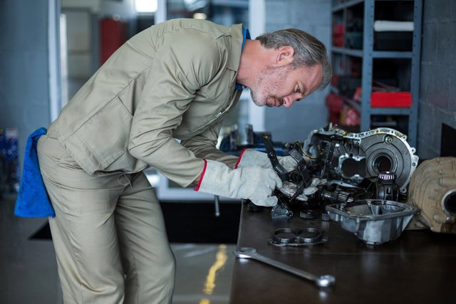 mechanic-checking-car-parts-1