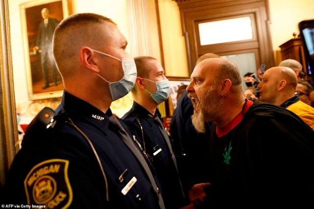 27855052-8275171-Protesters-tried-to-enter-the-Michigan-House-of-Representatives-a-111-158828368854.jpg