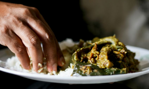 Why do indonesian people eat with their hands?