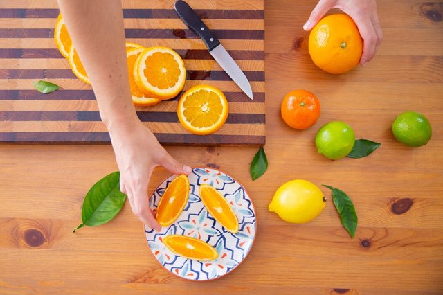 hand-taking-orange-piece-from-ceramic-plate_74855-5389.jpg