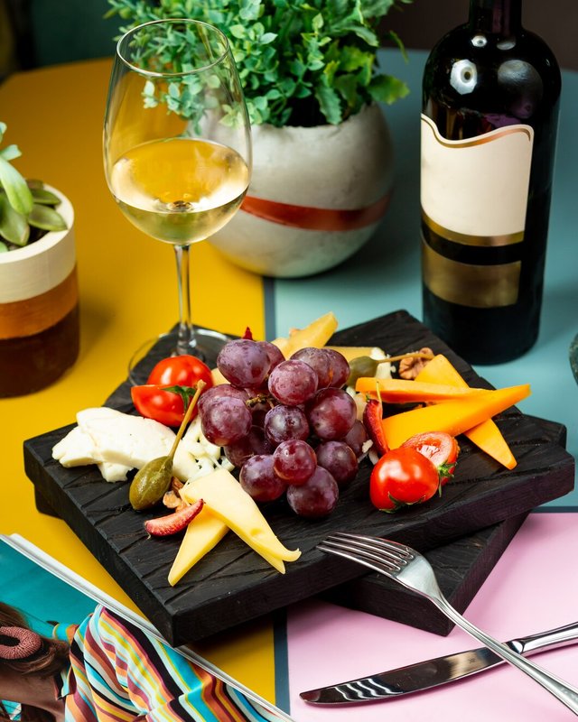 glass-wine-served-with-grape-cheese-tomato_140725-1780.jpg