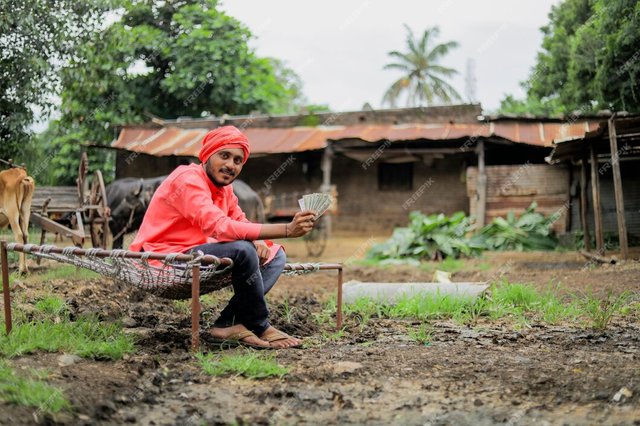 young-indian-farmer-counting-showing-money_75648-2654.jpg