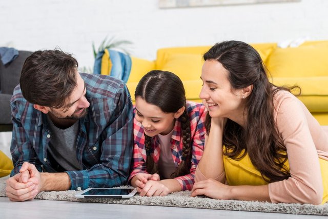 happy-family-sitting-floor-looking-mobile_23-2148456326.jpg