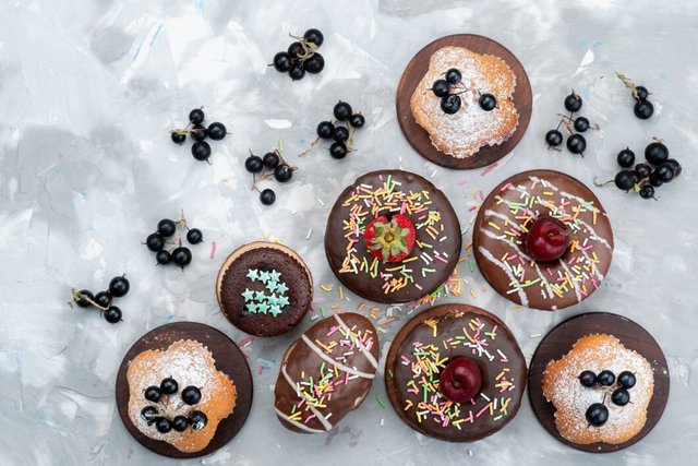 top-view-cakes-donuts-chocolate-based-with-fruits-candies-cake-biscuit_140725-22289.jpg