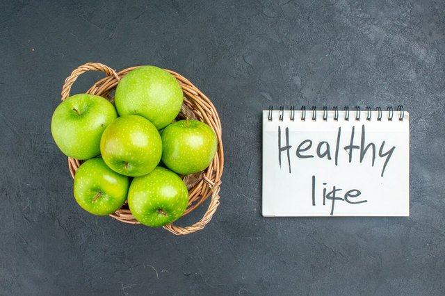 top-view-fresh-apples-wicker-basket-healthy-life-written-notepad-dark-surface_140725-63343.jpg