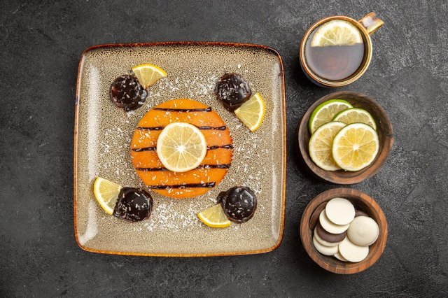 top-view-yummy-sweet-pie-with-lemon-slices-cup-tea-grey-background-cake-pie-biscuit-sweet-cookies_140725-121972.jpg