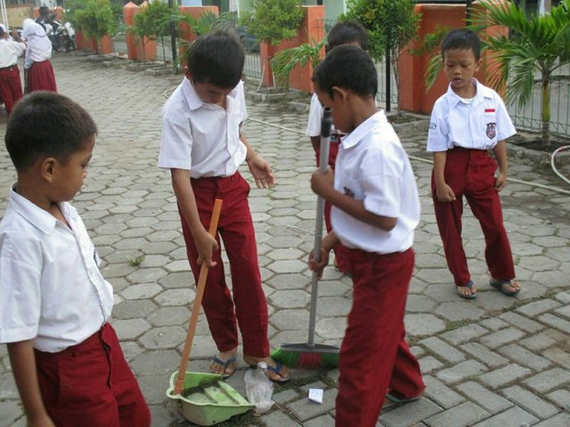 children cleaning the surroundings