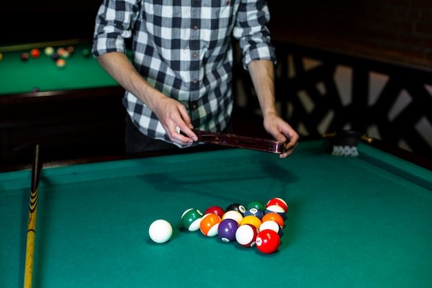 Free photo close-up man with pool triangle and balls