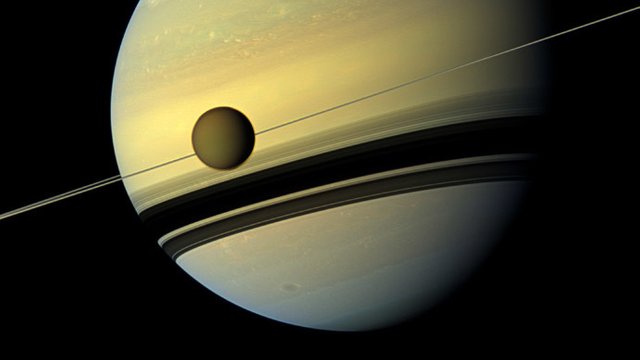 Titan in front of Saturn